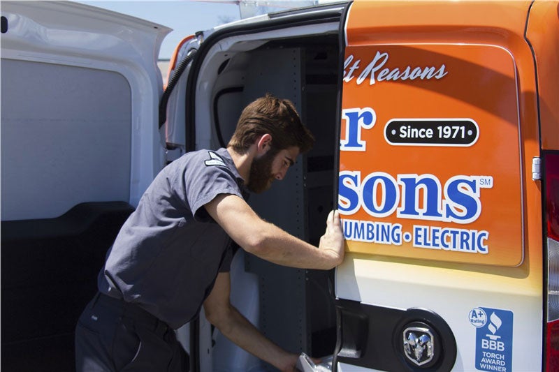 technician opening back door of van