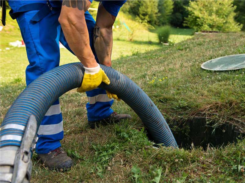 Person putting a pipe into the sewer line