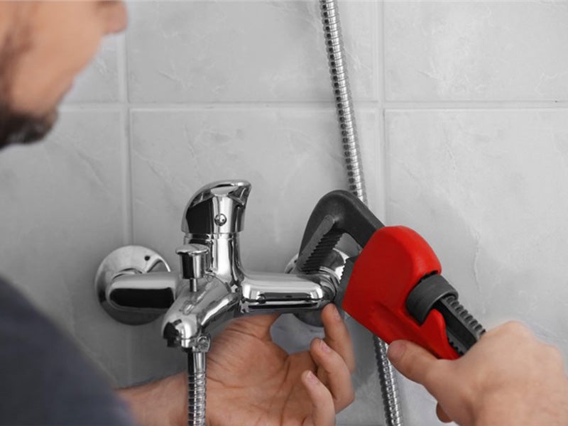 Plumber repairing a water tap