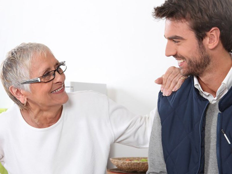 Old women and a young man talking