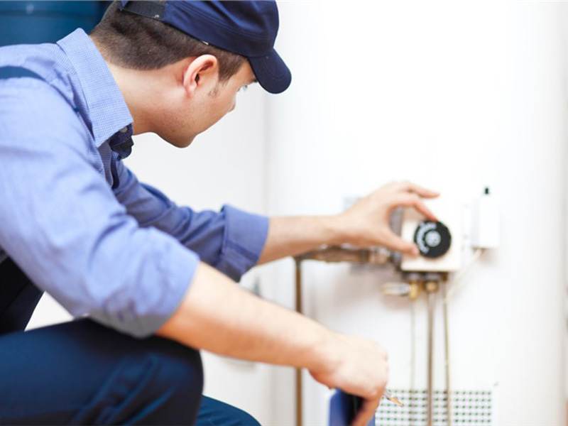 person-adjusting the water heater