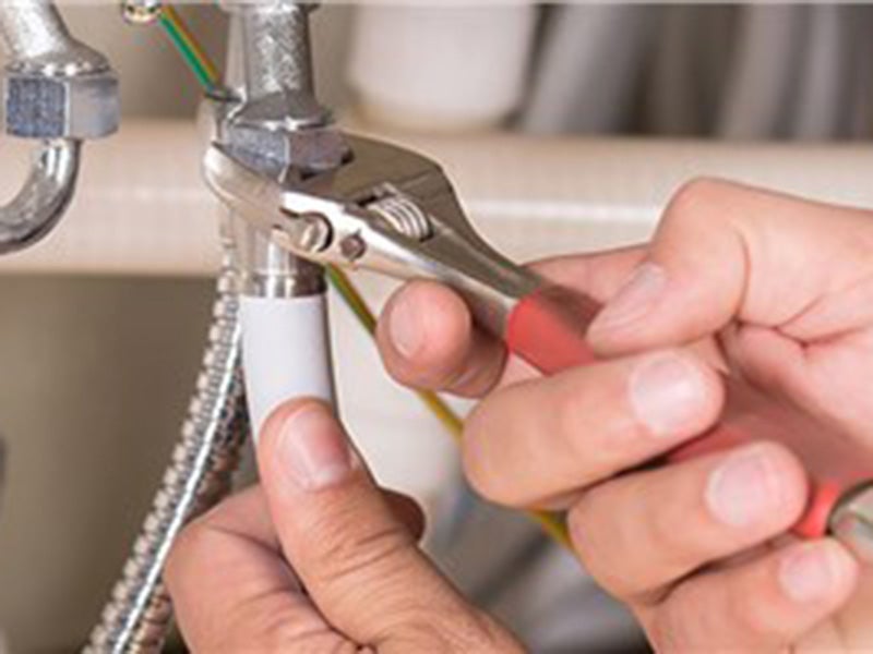 person fixing sink pipe