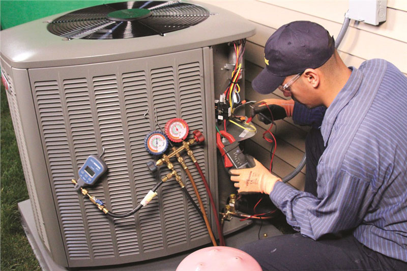 technician repairing AC unit