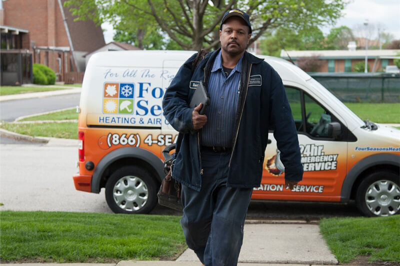 service technician walking to house from van