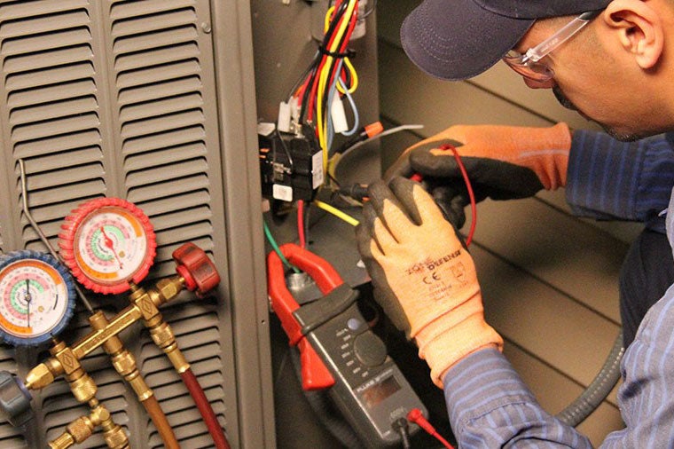 man repairing furnace