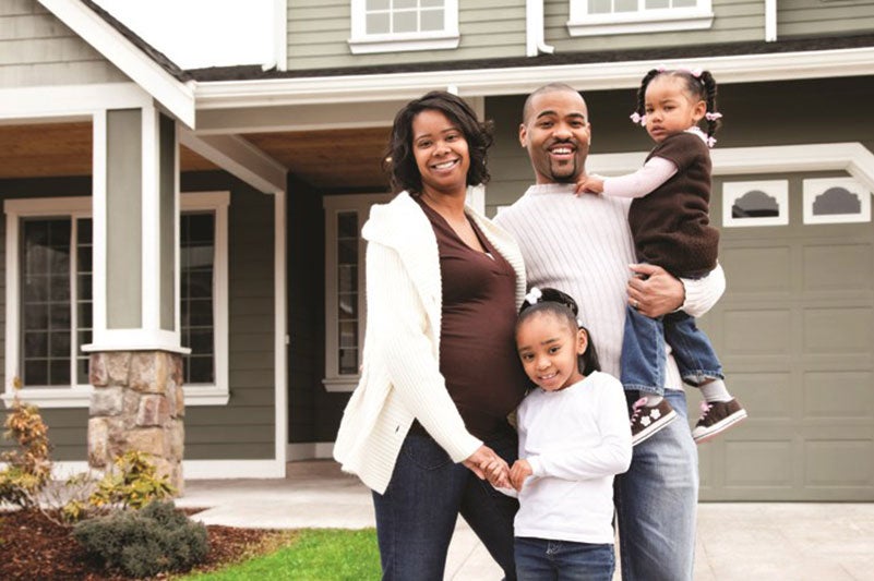 Family in front of house