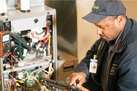 technician repairing furnace