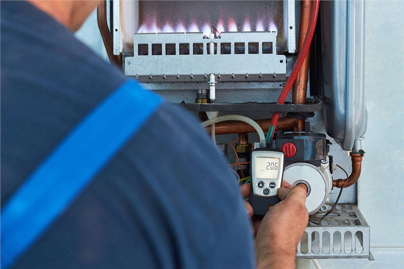 technician repairing furnace