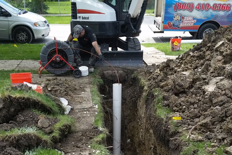 technician laying new sewer pipe