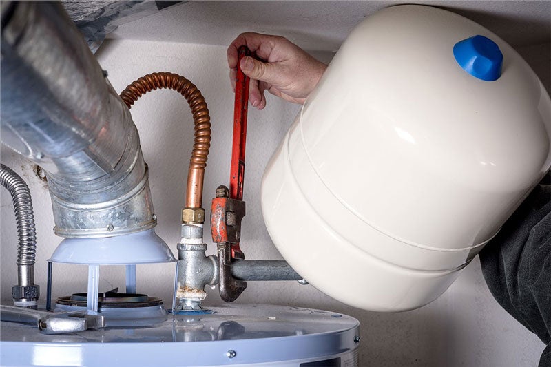 technician working on water heater