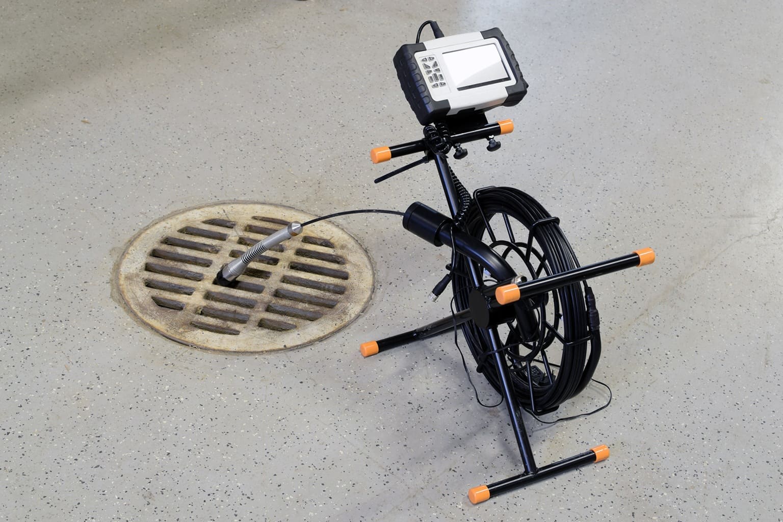 camera set up for a sewer video camera inspection next to floor drain