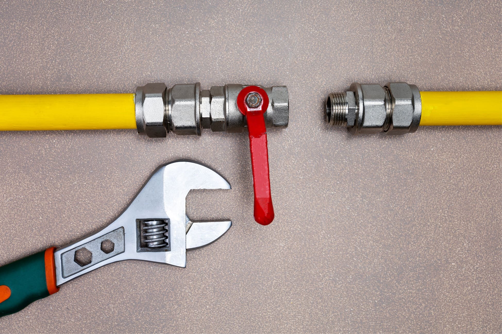 two gas pipes lying on a surface ready to be connected at the valve