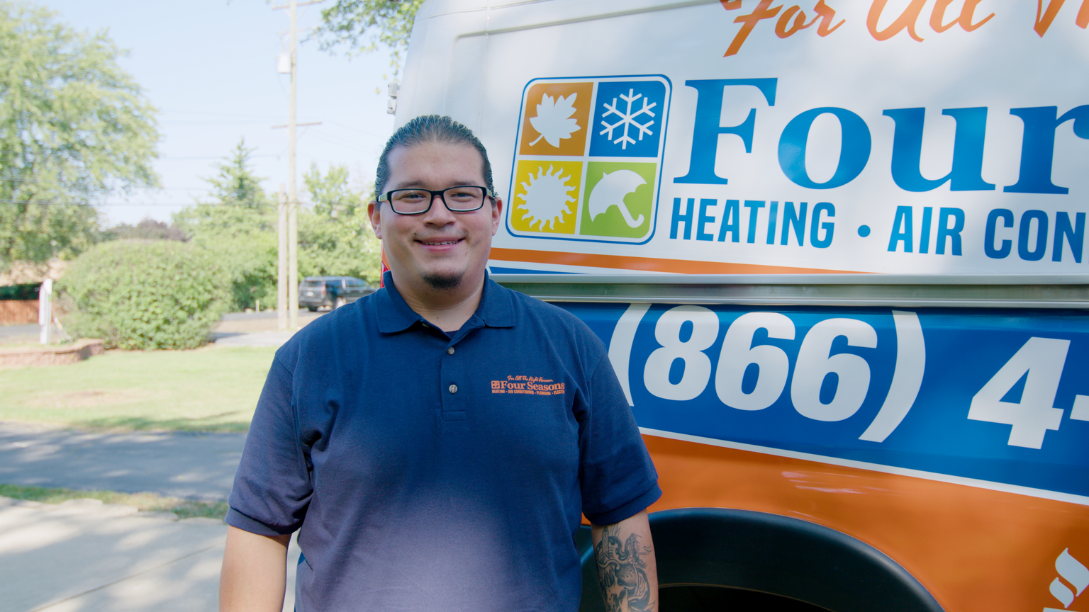 Adrian furnace technician by Four Seasons work truck